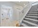 Elegant staircase with gray carpeting and white railings at 384 Orange Cosmos Blvd, Davenport, FL 33837
