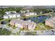 Aerial view of apartment community with lake, tennis court, and ample parking at 4105 Tropical Isle Blvd # 216, Kissimmee, FL 34741