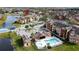 Aerial view of apartment community with pool, tennis courts, and lake at 4105 Tropical Isle Blvd # 216, Kissimmee, FL 34741