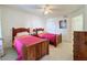Bright bedroom with two twin beds and wood furniture at 4105 Tropical Isle Blvd # 216, Kissimmee, FL 34741