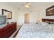 Main bedroom with a large bed, dresser and en-suite bathroom at 4105 Tropical Isle Blvd # 216, Kissimmee, FL 34741