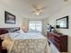 Spacious bedroom with lake view, ceiling fan, and ample closet space at 4105 Tropical Isle Blvd # 216, Kissimmee, FL 34741