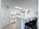 Efficient kitchen with white cabinetry and breakfast bar at 4105 Tropical Isle Blvd # 216, Kissimmee, FL 34741