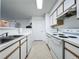 White kitchen with stove, microwave and dishwasher at 4105 Tropical Isle Blvd # 216, Kissimmee, FL 34741