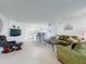Living room features tiled floors, green sofa, and kitchen access at 4105 Tropical Isle Blvd # 216, Kissimmee, FL 34741
