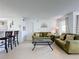Bright living room with green sofa, coffee table, and adjacent kitchen at 4105 Tropical Isle Blvd # 216, Kissimmee, FL 34741