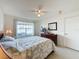 Main bedroom features a queen bed, dresser, and lake view at 4105 Tropical Isle Blvd # 216, Kissimmee, FL 34741