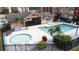 Community pool and spa with covered patio and seating at 4105 Tropical Isle Blvd # 216, Kissimmee, FL 34741