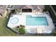 Community pool and spa with lounge chairs and patio area at 4105 Tropical Isle Blvd # 216, Kissimmee, FL 34741
