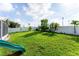 Spacious backyard with green grass and a playground at 435 Madina Cir, Davenport, FL 33837