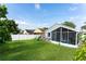 Spacious backyard featuring a screened patio and lush lawn at 435 Madina Cir, Davenport, FL 33837
