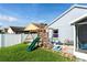 Large backyard with playground, screened patio, and grassy area at 435 Madina Cir, Davenport, FL 33837