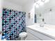 Clean bathroom with a blue-themed shower curtain and a white vanity at 435 Madina Cir, Davenport, FL 33837