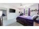 Bedroom with a queen bed, TV, and view of backyard at 435 Madina Cir, Davenport, FL 33837