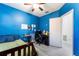 Blue bedroom with a bed, desk and window with blinds at 435 Madina Cir, Davenport, FL 33837