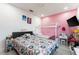 Bedroom with pink walls, two beds and a TV at 435 Madina Cir, Davenport, FL 33837
