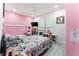 Bedroom with pink walls, two beds and a TV at 435 Madina Cir, Davenport, FL 33837