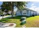 Blue single-Gathering home with a two-car garage and a lush green lawn at 435 Madina Cir, Davenport, FL 33837