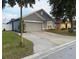 Charming single-story home featuring a gray exterior, a two-car garage, and a well-maintained front yard at 435 Madina Cir, Davenport, FL 33837