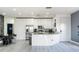 Bright, modern kitchen with stainless steel appliances, sleek white cabinets, and granite countertops at 435 Madina Cir, Davenport, FL 33837