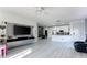 Open-concept living room, dining area, and kitchen with modern finishes and ample natural light at 435 Madina Cir, Davenport, FL 33837