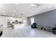 Bright and spacious living room with modern décor, connecting the kitchen and dining areas at 435 Madina Cir, Davenport, FL 33837