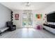 Bright living room with hardwood floors, ceiling fan, and access to backyard patio at 435 Madina Cir, Davenport, FL 33837