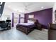 Cozy main bedroom features purple accents, a comfortable bed, and a bright window at 435 Madina Cir, Davenport, FL 33837