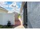 Side yard access with gate and small patio area at 435 Madina Cir, Davenport, FL 33837