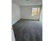 Condo bedroom with grey carpet and window at 4518 Commander Dr # 1918, Orlando, FL 32822
