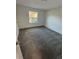 Bright bedroom with gray carpet and a window at 4518 Commander Dr # 1918, Orlando, FL 32822