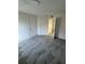 Condo bedroom with grey carpet, double closets and bathroom access at 4518 Commander Dr # 1918, Orlando, FL 32822