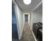 Clean hallway with carpet, leading to laundry and other rooms at 4518 Commander Dr # 1918, Orlando, FL 32822