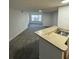 Spacious living room with grey carpet and large window at 4518 Commander Dr # 1918, Orlando, FL 32822