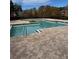 Community pool with brick deck and surrounding trees at 4518 Commander Dr # 1918, Orlando, FL 32822