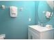 Small bathroom with teal walls and white vanity at 4608 Cumbrian Lakes Dr, Kissimmee, FL 34746
