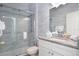 Modern bathroom with a glass shower and granite countertop at 4608 Cumbrian Lakes Dr, Kissimmee, FL 34746