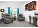 Relaxing living room with two armchairs and large artwork at 4608 Cumbrian Lakes Dr, Kissimmee, FL 34746