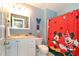 Bathroom with white vanity, Mickey Mouse shower curtain at 4724 Vero Beach Pl, Kissimmee, FL 34746