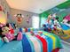 Mickey Mouse-themed bedroom with twin beds and mural at 4724 Vero Beach Pl, Kissimmee, FL 34746