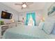 Bedroom with a queen-size bed and coastal decor at 4724 Vero Beach Pl, Kissimmee, FL 34746