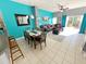Dining table with six chairs and a view of the living room at 4724 Vero Beach Pl, Kissimmee, FL 34746