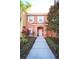 Two-story peach house with walkway, landscaping, and shutters at 4724 Vero Beach Pl, Kissimmee, FL 34746