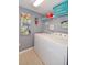 Laundry room with washer, dryer, and shelving at 4724 Vero Beach Pl, Kissimmee, FL 34746