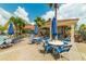Poolside seating with tables and umbrellas at 4724 Vero Beach Pl, Kissimmee, FL 34746