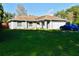 Single-story home featuring a gray exterior, attached garage, and a spacious front yard at 500 16Th St, Saint Cloud, FL 34769