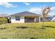 Spacious backyard with grassy lawn and screened patio at 5014 E Fountainwood Dr, Saint Cloud, FL 34772