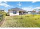 Large backyard with lush grass and view of the house at 5014 E Fountainwood Dr, Saint Cloud, FL 34772