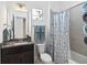 Clean bathroom with granite countertop, shower/tub combo, and patterned shower curtain at 5014 E Fountainwood Dr, Saint Cloud, FL 34772