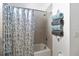Bathroom with shower/tub combo, neutral tile, and decorative towel rack at 5014 E Fountainwood Dr, Saint Cloud, FL 34772